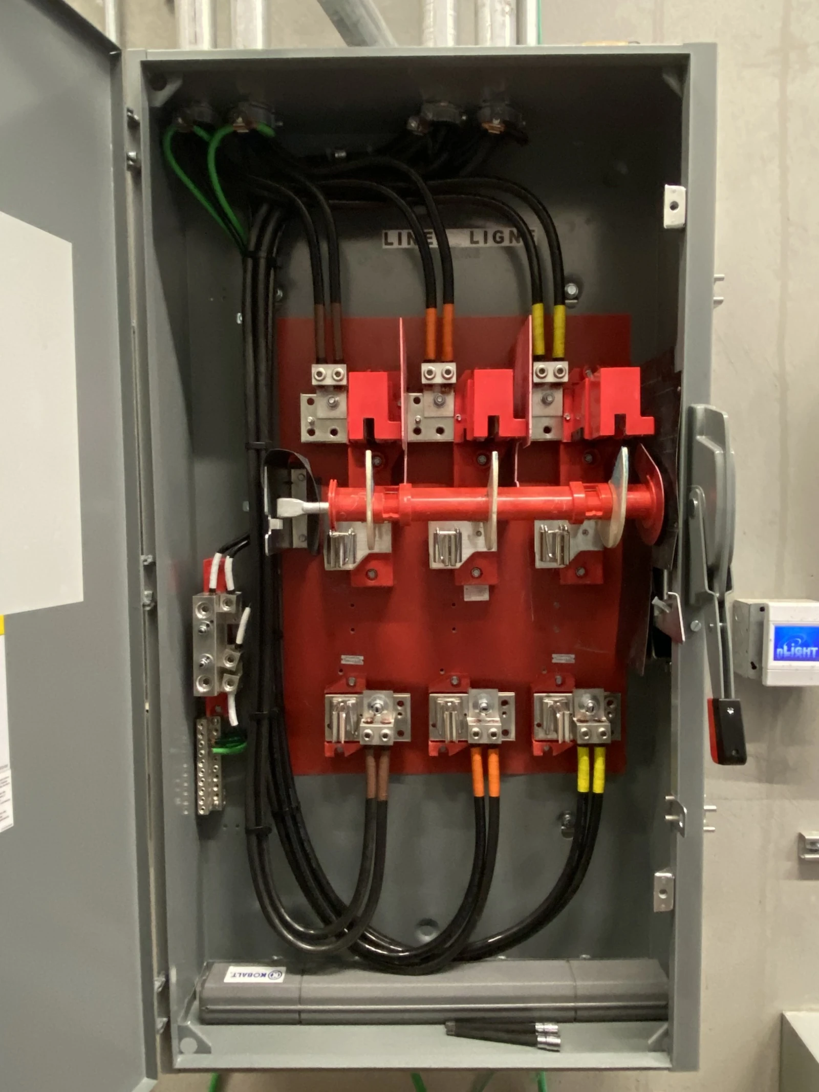 Electrician working on a U.S. breaker panel at the Pearl Harbor Aviation Museum in Hawaii